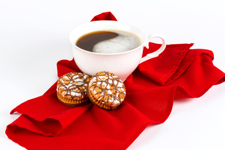 Cup of coffee and cookies on a red napkin.の写真素材