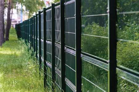 Fencing made of metal mesh to protect the territory.の写真素材