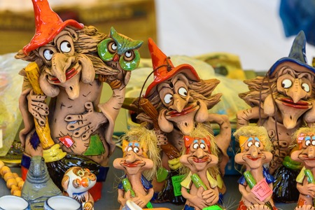 Sale of souvenir figurines of witches from clay. Russia, Suzdal, September 2017.
