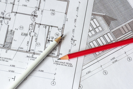 The architectural plan of the house is printed on a white sheet of paper. A red and  white pencil on it. June 2018, Russia, Moscowの写真素材