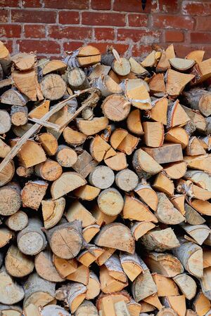 Brick log with wood for the furnace. Firewood. Preparation for the winter.