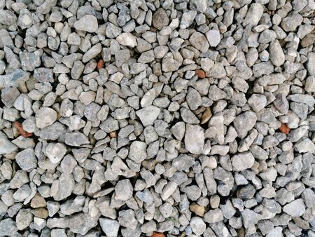 Gray gravel pebble stone texture. Small road stone background.