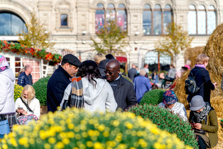 Russia, Moscow, October 2019. Tourists of different nationalities walk on Red Square at the harvest festival. Moscow autumn.のeditorial素材