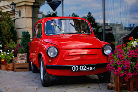 Russia, Kazan June 2019. Flower beds and an old red car for decoration.