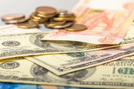 Cash banknotes and coins background. The background of the American and Russian money banknotes and...