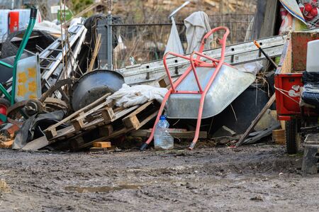 Warehouse broken garden tools. A broken wheelbarrow and other garden tools and fixtures.の写真素材