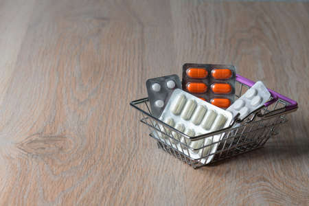 Package of medicine tablets in the shopping cart. Purchase of medicines pills. Protection from virus infection.の写真素材
