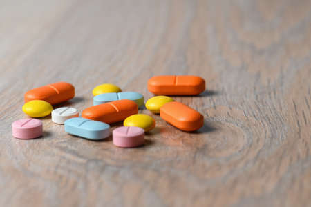 Assorted color tablets close-up on the table. Concept of protection and treatment of coronavirus infection. Copy space.の写真素材