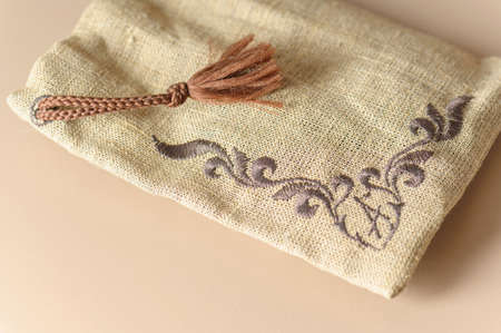 A small burlap canvas bag with rope ties. Rustic style for a gift.の写真素材
