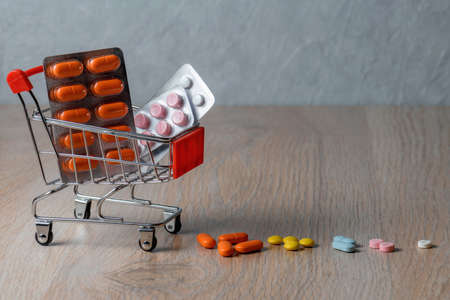Packaging of medical tablets in the shopping cart. Purchase of medicinal tablets. Protection from virus infection.の写真素材