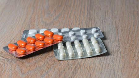 Close-up of tablet packages on the table. Concept of protection and treatment of coronavirus infection.の写真素材