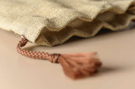 A small burlap canvas bag with rope ties. Rustic style for a gift.の写真素材