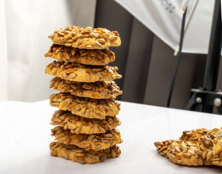 Simple cookie with nuts, seeds and cereals isolated. Oatmeal sugar bitten cookies, sunflower seed biscuit. Round biscuit top viewの写真素材