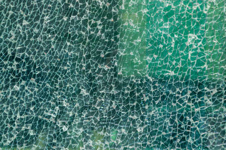 Cracked glass texture background. Broken tempered glass with cracks, shattered window pattern, chapped transparent surface wallpaper, safety shards mockupの写真素材
