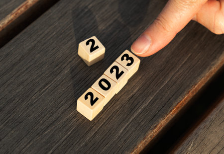 Blank wooden blocks with 2023. Hands move wooden cubes, new year wooden blocks, wood cubes for new year business, 23 calendar conceptの写真素材