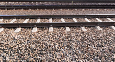railway line closeup. Train tracks with track ballast stones, metal rails, railway track