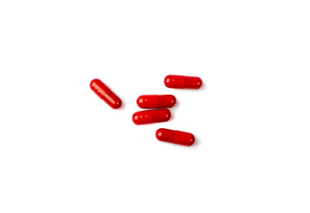 red pills. Capsule set isolated, analgesic, painkiller drugs, sedative pill collection, medicine capsules group on white backgroundの写真素材