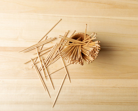 Wooden Toothpicks on Wood Background with Copy Space, Flat Lay Tooth Picks, Toothpicks Top View Mockup with Space for Text, Daily Dental Care Concept Bannerの写真素材