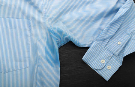 Wet Armpit on Blue Shirt, Sweaty Arm Pit, Armpits Problem, Wet Underarm, Sweat Stains on Clothes, Perspiration, Hyperhidrosis Conceptの写真素材