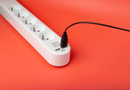 USB Plugs, Power Strip, Extension Cable, Electricity Strip USB Charging, Home Socket, Power Extender, Extension Cord on Pink Background with Copy Spaceの写真素材