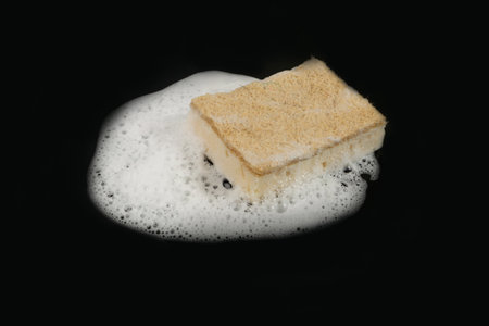 Natural Soapy Sponge with Foam, Eco Brown Sponges, Eco Friendly Hygiene Accessory, Scotch Brite Dishwasher on Black Backgroundの写真素材