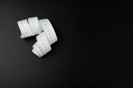 Measuring Tape Isolated, Measure Tapes, Sewing Metric Tape on Black Backgroundの写真素材