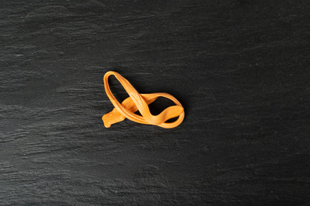 Chewing Gum on Black Plate, Single Fruit Color Bubble Gum, Sweet Pink Bubblegum Top View with Copy Spaceの写真素材