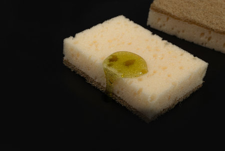 Natural Soapy Sponge with Detergent Drop, Liquid Soap on Eco Brown Sponges on Black Background, Copy...