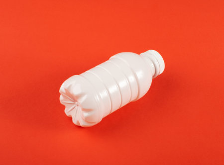 Empty Plastic Milk Bottle, White Plastic Bottle, Global Pollution Concept, Pet Bottles on Red...