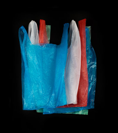 Many Plastic Bags on Black Background, Crumpled Plastic Bag after Shopping, Cellophane Packaging Waste, Used Crumpled Disposable Pouchの写真素材