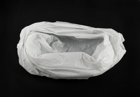 White Plastic Bags on Black Background, Crumpled Plastic Bag after Shopping, Cellophane Packaging Waste, Used Crumpled Disposable Pouchの写真素材