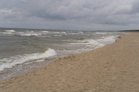 Stormy Baltic Sea Coast, Cloudy Weather, Poland Shoreline, Muddy Waves, Cold Brown Baltic Sea Water, Cold Summerの写真素材
