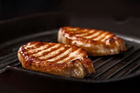 Steaks in a cast iron panの写真素材