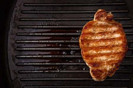 Steaks in a cast iron panの写真素材