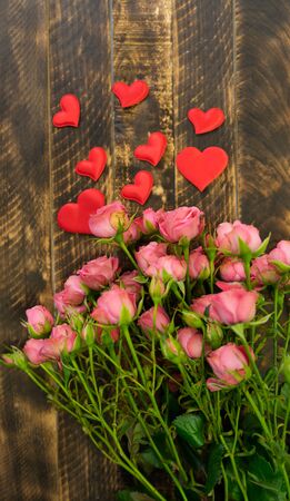 Bouquet of pink roses on old wooden board background, valentines dayの写真素材