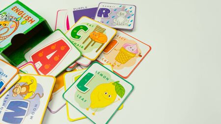 Many cards with different letters of the alphabet on a white background, learn