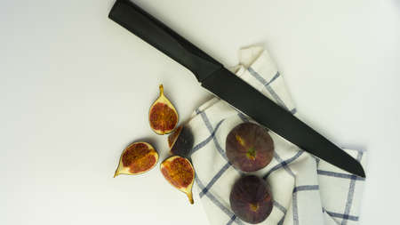 Fresh delicious figs on a wooden Board with a white background. Banner with space for text.