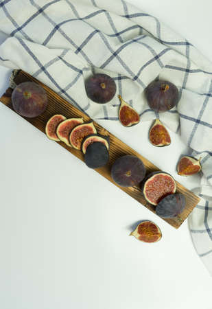 Fresh delicious figs on a wooden Board with a white background. Banner with space for text.
