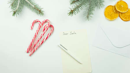 Children's letter to Santa Claus. Christmas decorations, candy canes. On white background. Copy...