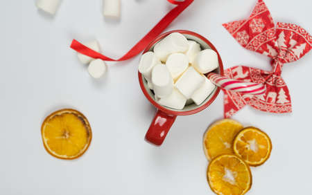 New year concept. Red cup with marshmallows close up on white background