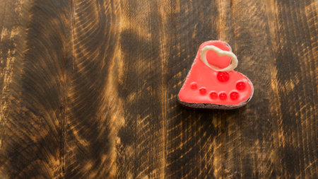 Valentine's day concept. Red heart on a wooden background. Sweet gift. A symbol of love, happiness and devotion. View from above. Copy spaceの写真素材