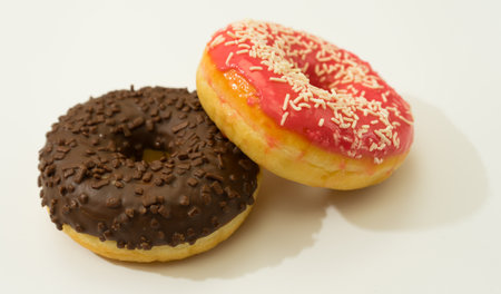 Donuts isolated on white background. Tasty glazed donuts closeup.の写真素材
