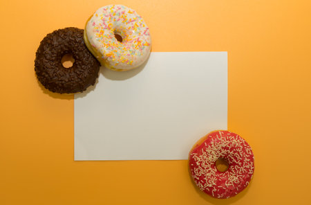 Donuts isolated on yellow background. Delicious glazed donuts close-up.の写真素材
