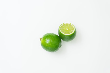 Ripe green lime citrus lime slice on white background. isolateの写真素材