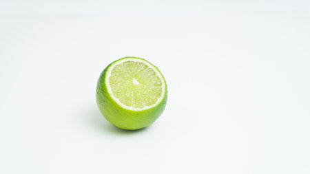 Ripe green lime citrus lime slice on white background. isolateの写真素材