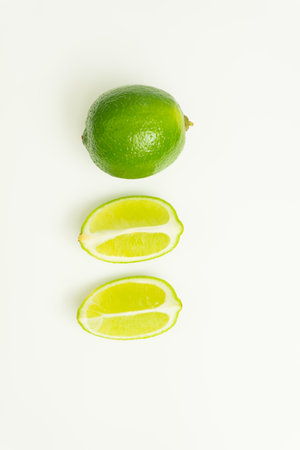 Ripe green lime citrus lime slice on white background. isolateの写真素材