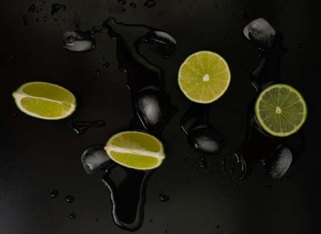 fresh lime with ice cubes on black background with space for text. Conceptの写真素材