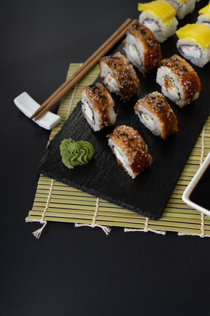 Sushi selection on black slate, black food border backgroundの写真素材