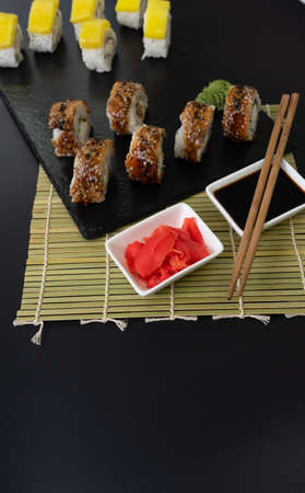 Sushi selection on black slate, black food border backgroundの写真素材