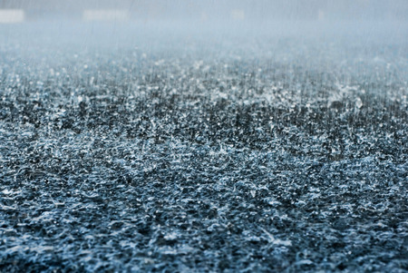 Drops of heavy rain on asphalt road. Macroの写真素材